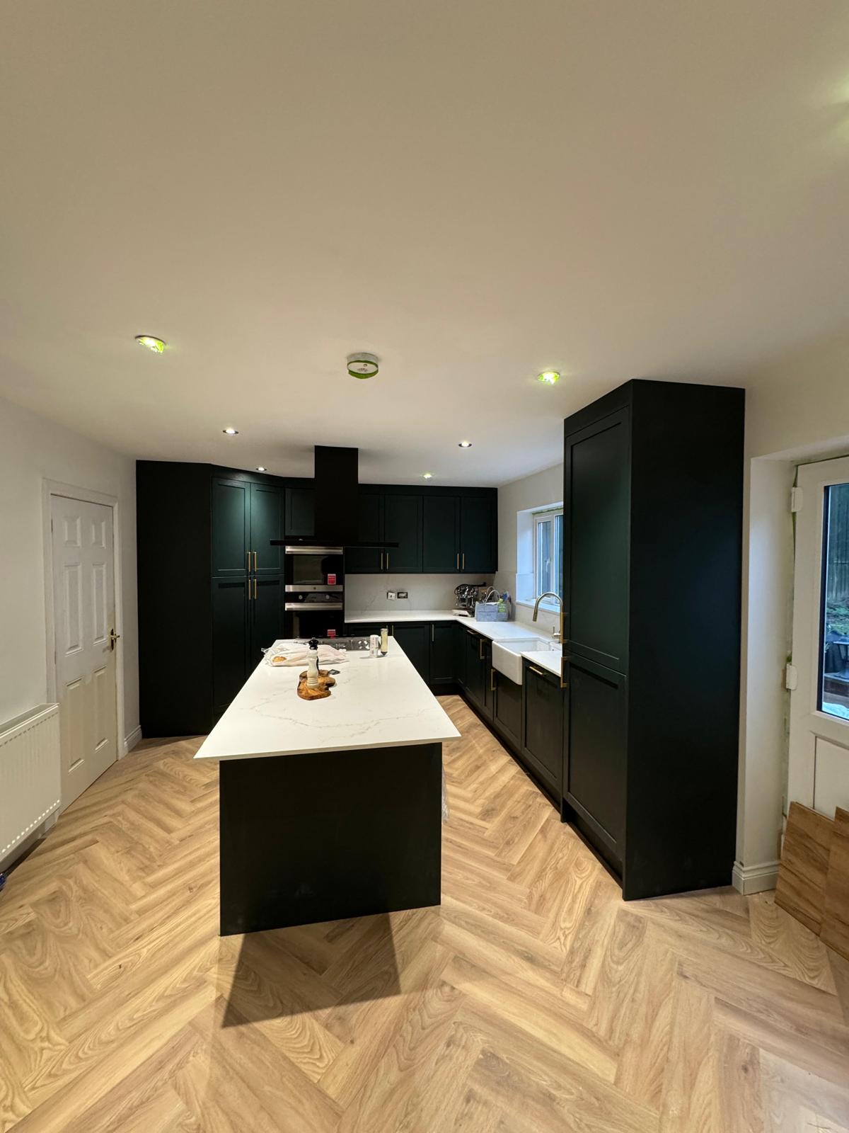 Painted shaker kitchen in dark green with quartz top