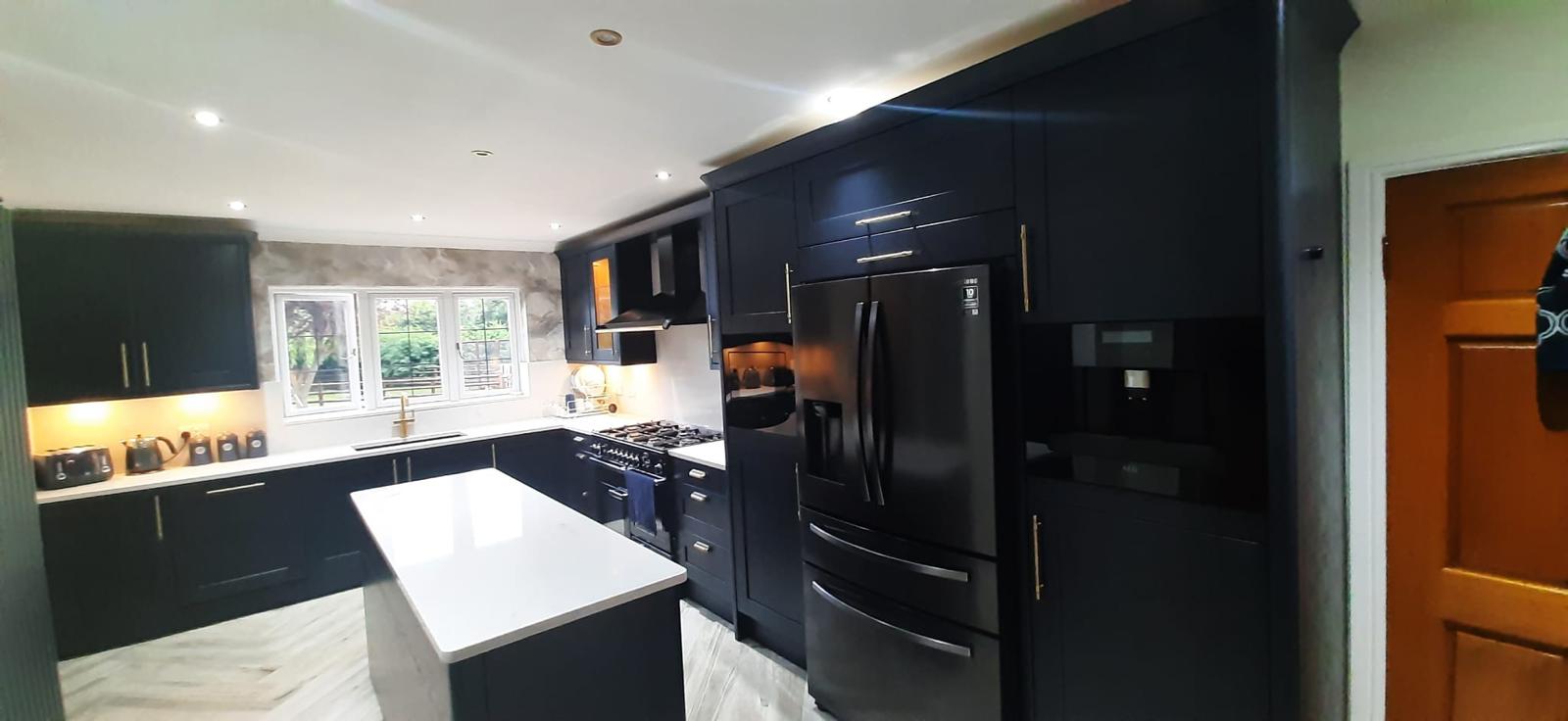 In-frame navy shaker kitchen with brass cup handles